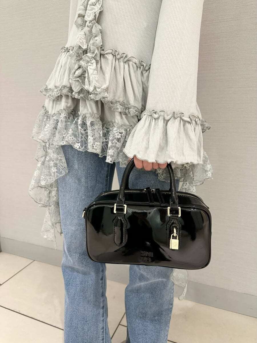 グリーン系のTシャツ/カットソー、ブルー系のその他パンツ、ブラック系のボストンバッグを着用したレディースの秋コーディネートの6枚目の写真