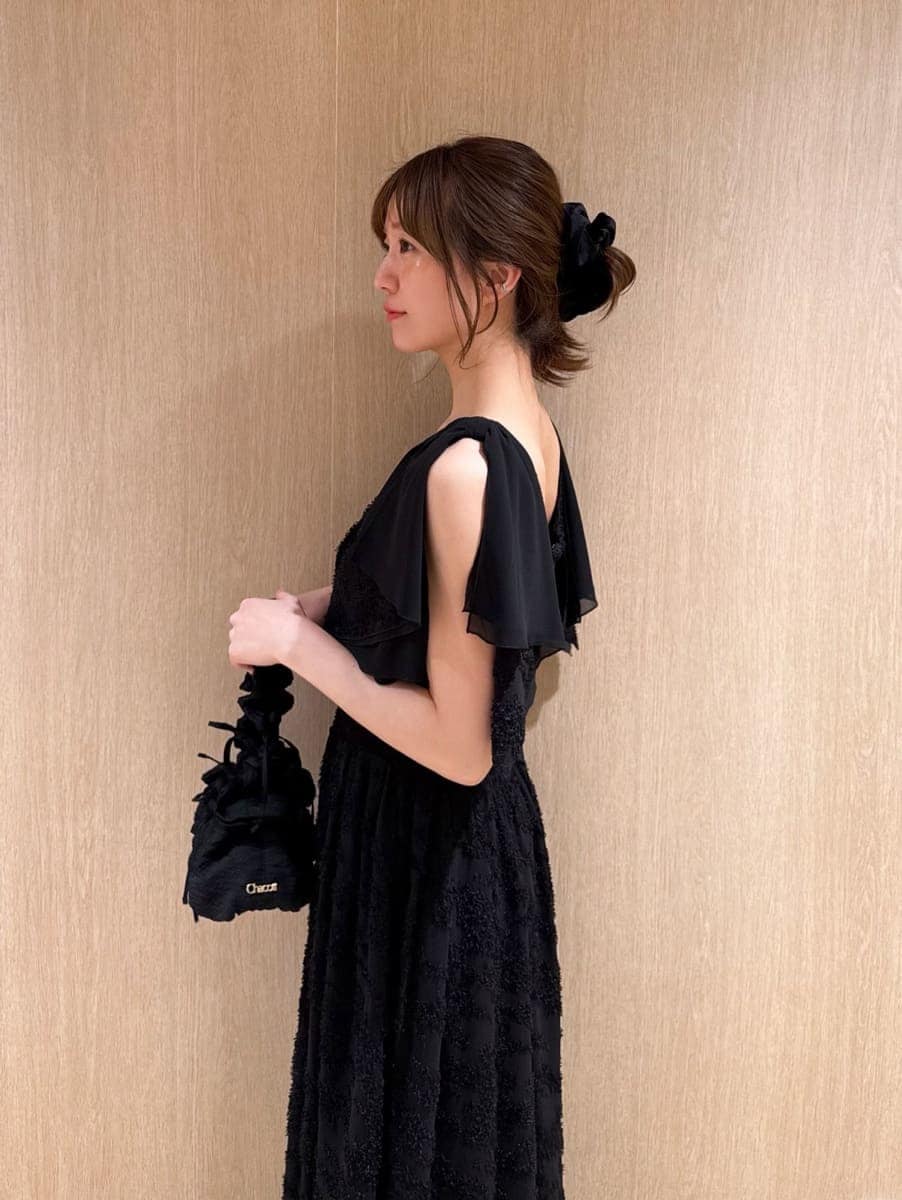 ブラック系のワンピース、ブラック系のパンプスを着用したレディースの春コーディネートの4枚目の写真