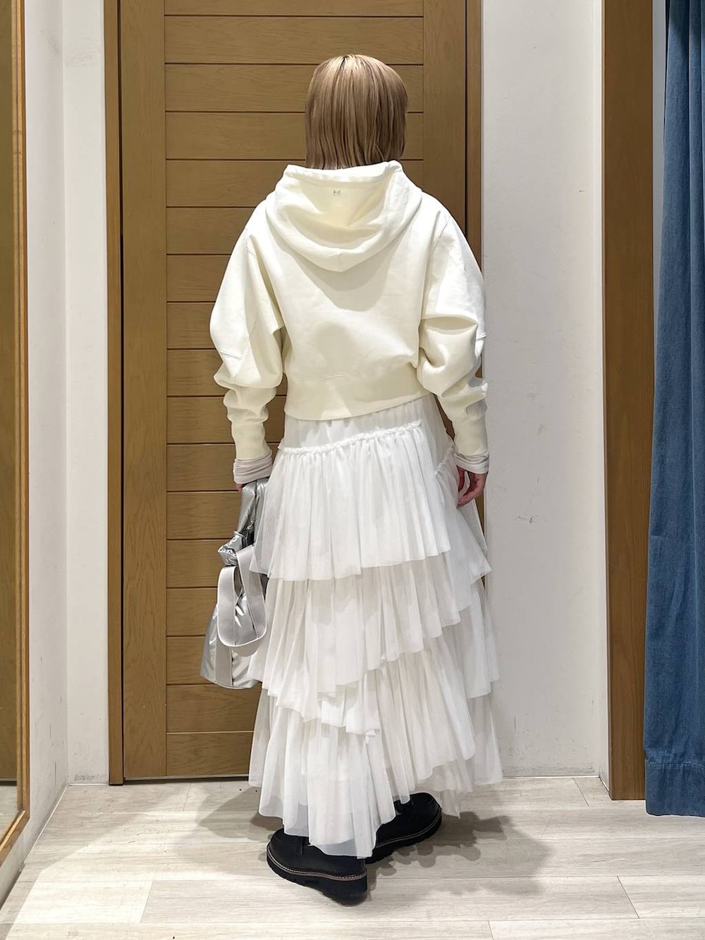 シルバー系のトートバッグ、ブラック系のローファー、ホワイト系のTシャツ/カットソーを着用したレディースの春コーディネートの5枚目の写真