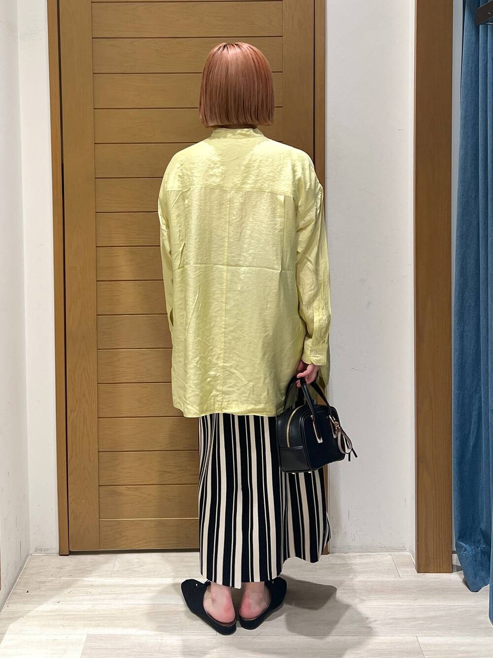 イエロー系のシャツ/ブラウス、ブラック系のショルダーバッグ、ブラック系のその他シューズを着用したレディースの春コーディネートの4枚目の写真