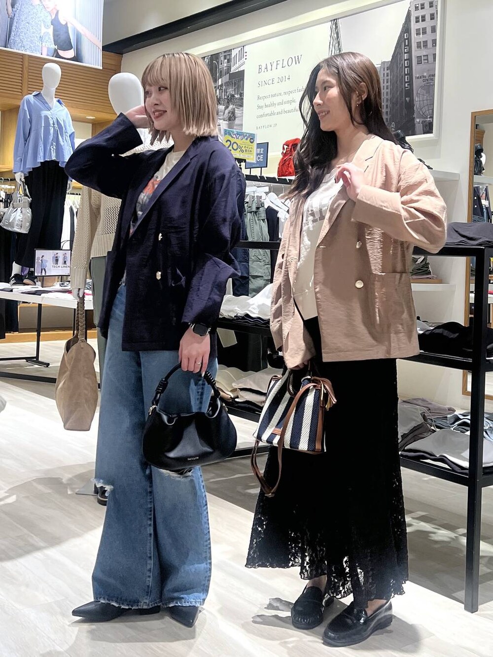 ブルー系のデニムパンツ、ブラック系のハンドバッグ、ブラック系のパンプスを着用したレディースの春コーディネートの2枚目の写真