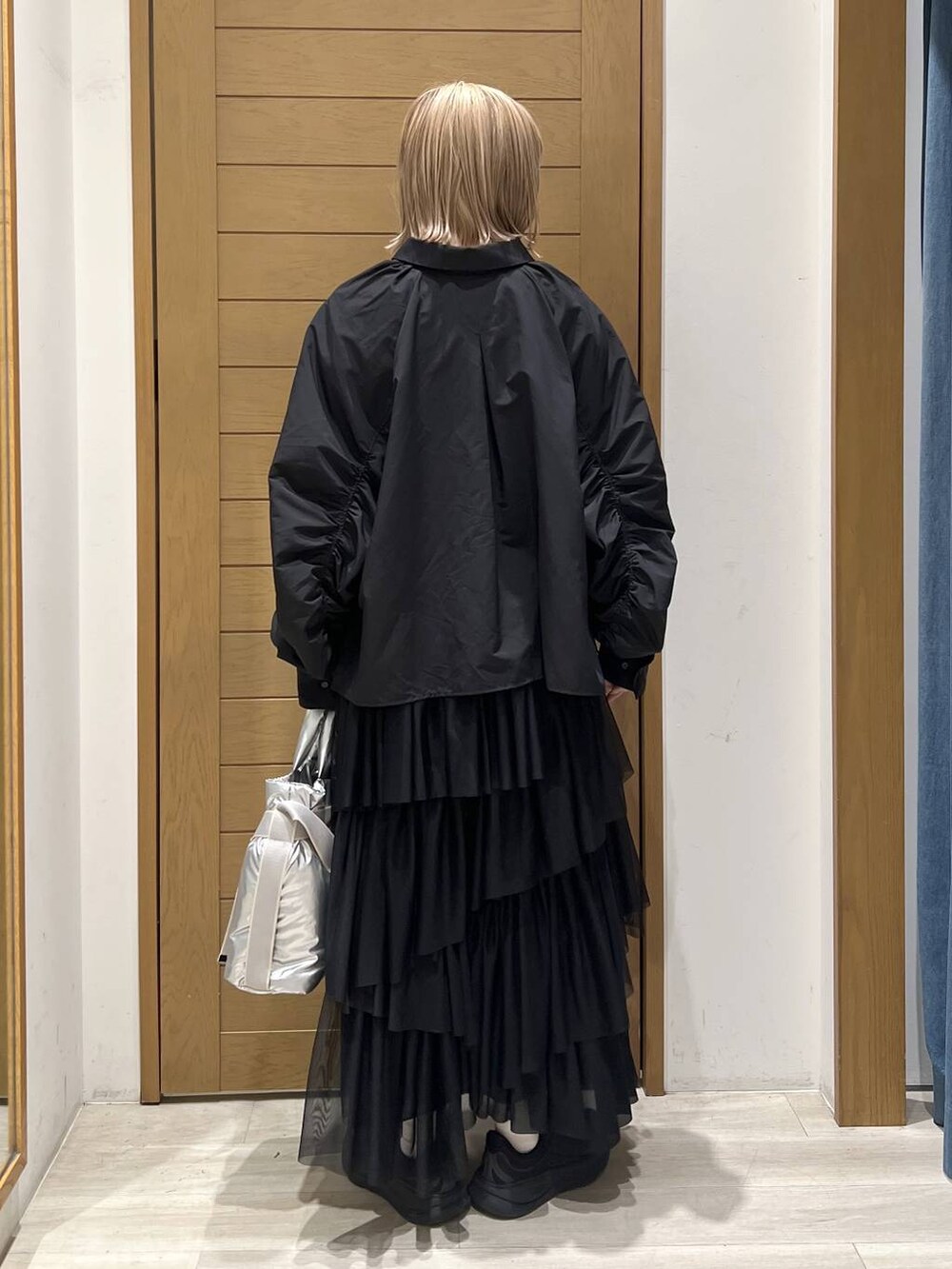 シルバー系のトートバッグ、ブラック系のシャツ/ブラウス、ブラック系のスカートを着用したレディースの春コーディネートの7枚目の写真