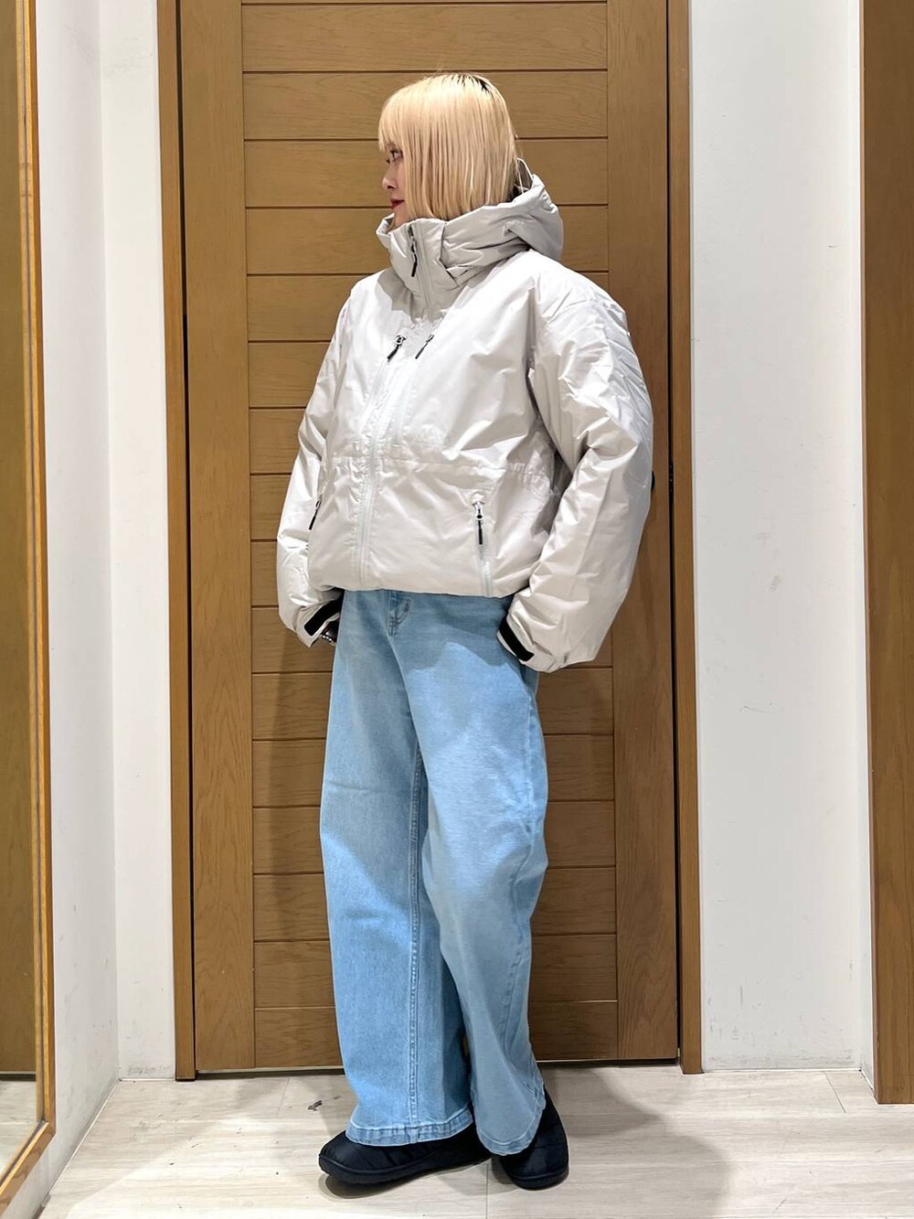 ホワイト系のダウンジャケット/コート、ブルー系のデニムパンツを着用したレディースの冬コーディネートの2枚目の写真