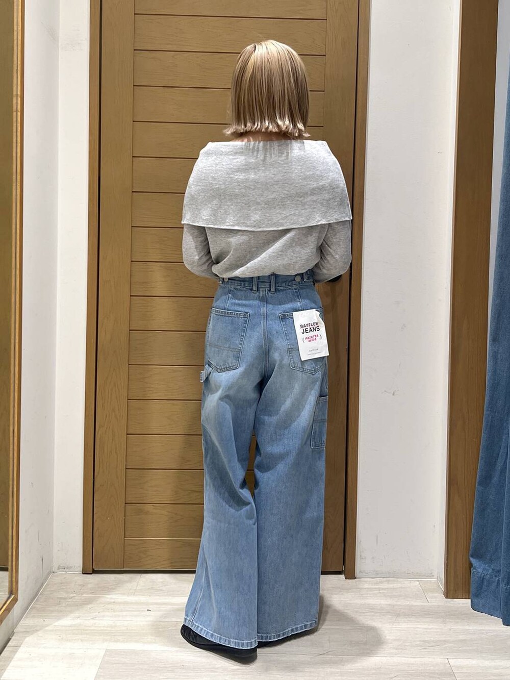 ブラック系のハンドバッグ、ブルー系のデニムパンツ、ブラック系のローファーを着用したレディースの春コーディネートの4枚目の写真