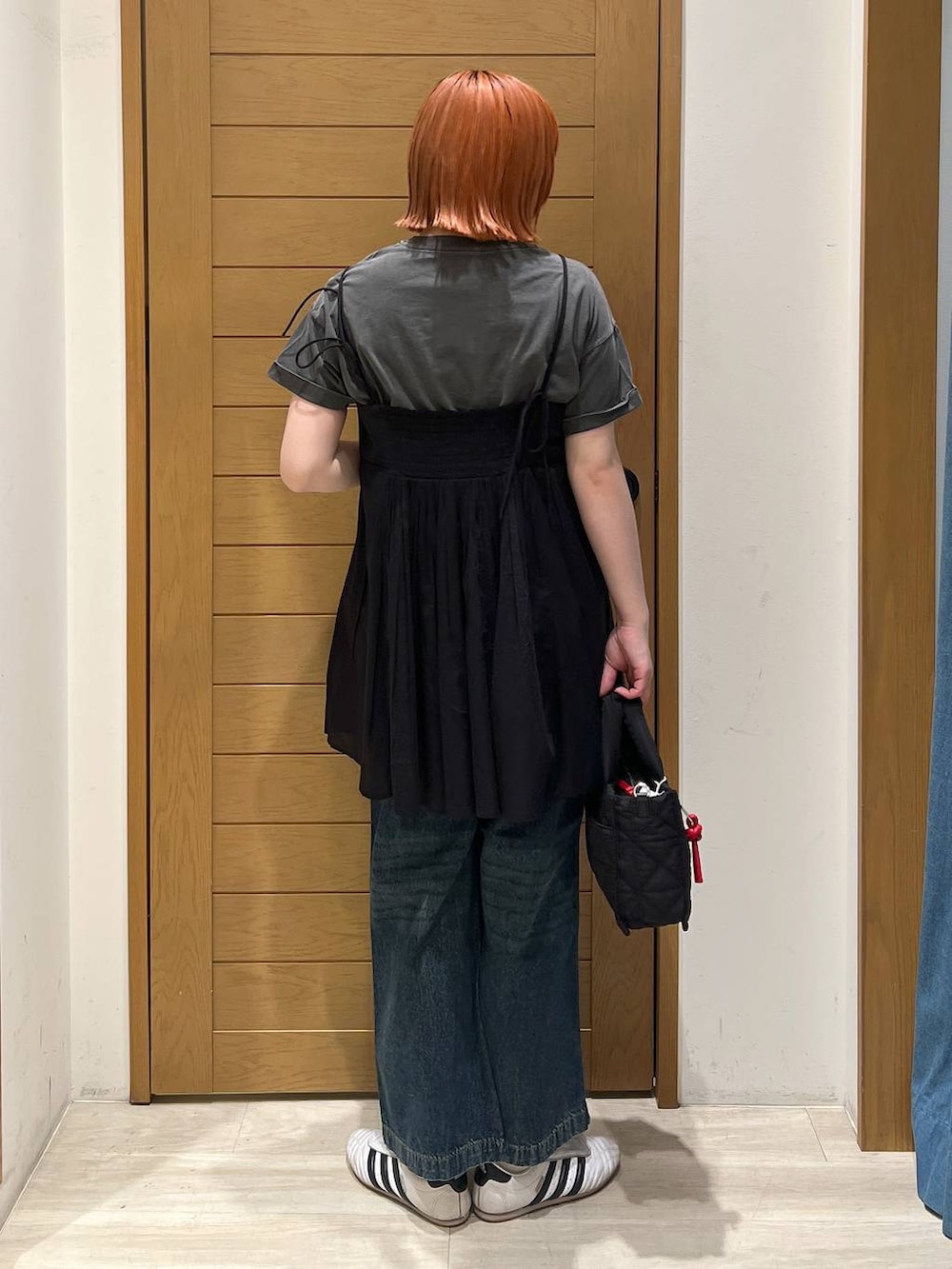 グレー系のTシャツ/カットソー、ブルー系のデニムパンツ、ブラック系のショルダーバッグを着用したレディースの夏コーディネートの5枚目の写真