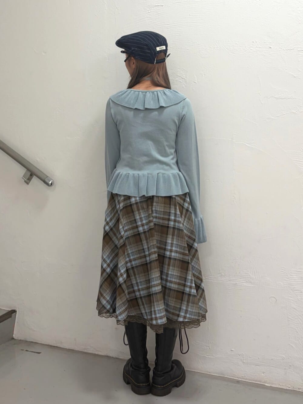 ブラウン系のスカート、ブルー系のニット/セーター、ブルー系のハンチング/ベレー帽を着用したレディースの冬コーディネートの4枚目の写真