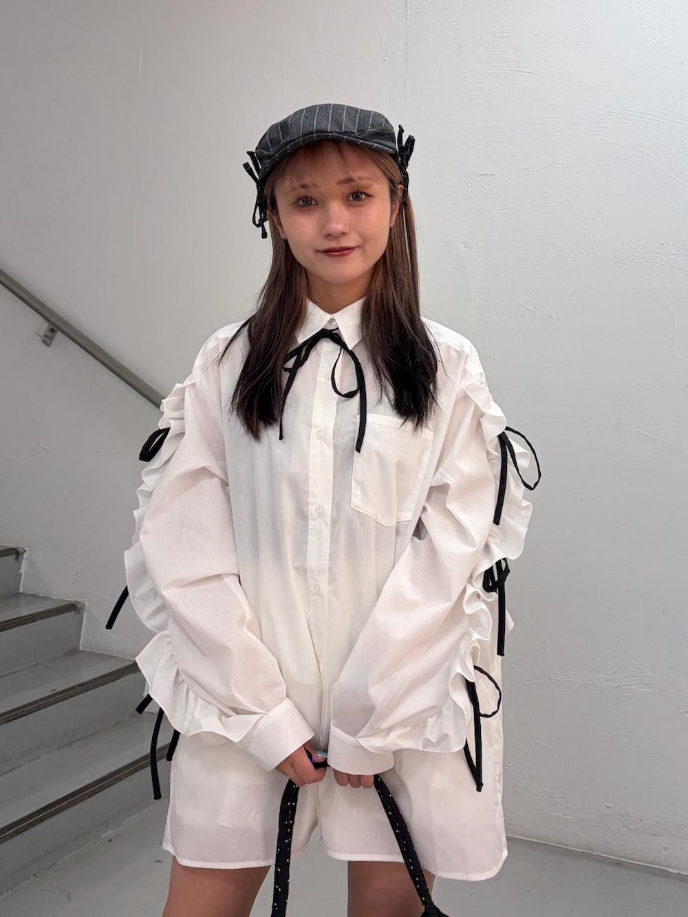 ホワイト系のシャツ/ブラウス、ブラック系のトートバッグ、グレー系のハンチング/ベレー帽を着用したレディースの春コーディネートの5枚目の写真