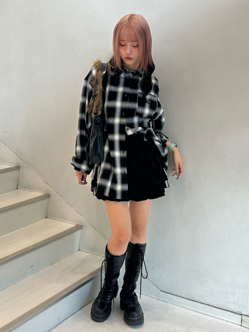 ブラック系のシャツ/ブラウス、ブラック系のスカート、ブラック系のハンドバッグを着用したレディースの秋コーディネートの2枚目の写真