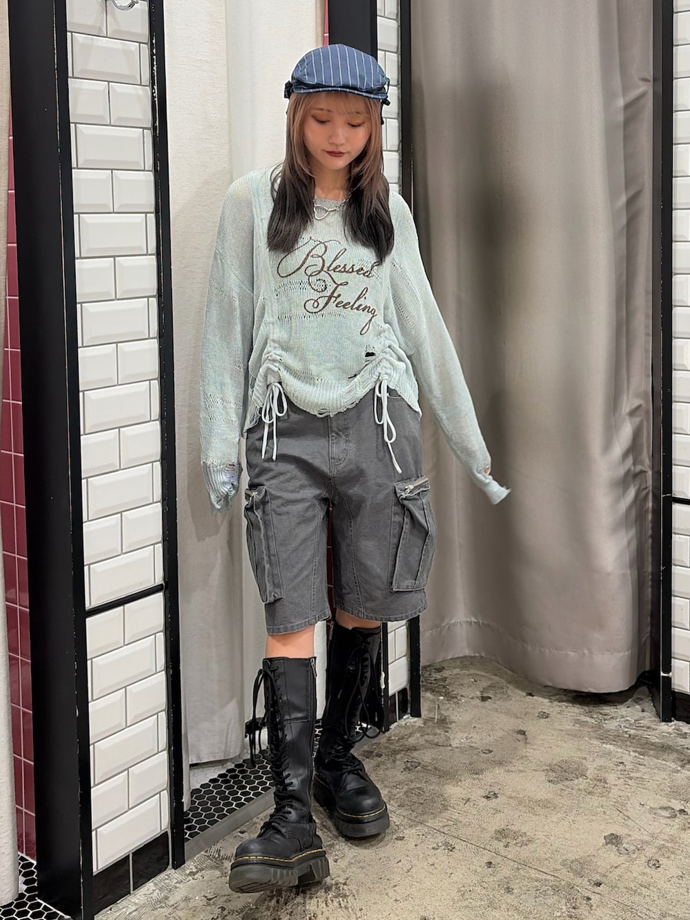 ブルー系のニット/セーター、ブラック系のカーゴパンツ、ブルー系のハンチング/ベレー帽を着用したレディースの冬コーディネートの2枚目の写真