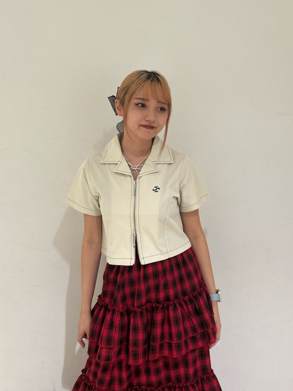 ホワイト系のシャツ/ブラウス、レッド系のスカート、ゴールド系のネックレスを着用したレディースの春コーディネートの4枚目の写真