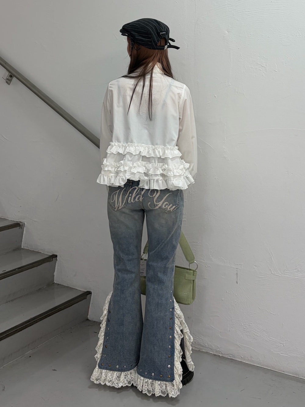 ホワイト系のシャツ/ブラウス、ブルー系のデニムパンツ、グリーン系のハンドバッグを着用したレディースの冬コーディネートの4枚目の写真