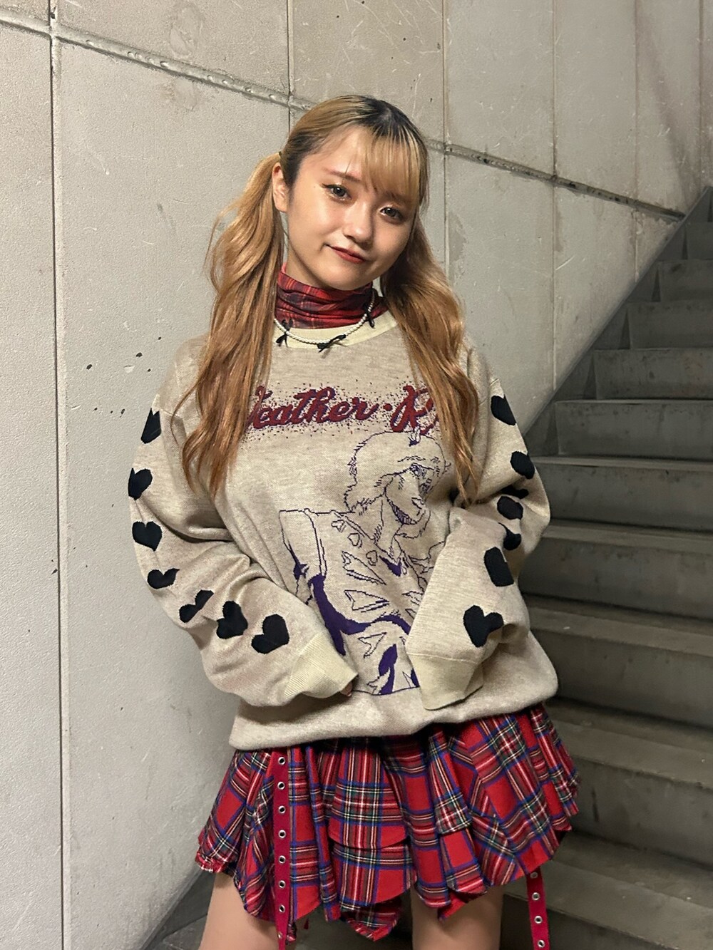 ホワイト系のニット/セーター、レッド系のスカート、レッド系のTシャツ/カットソーを着用したレディースの秋コーディネートの4枚目の写真