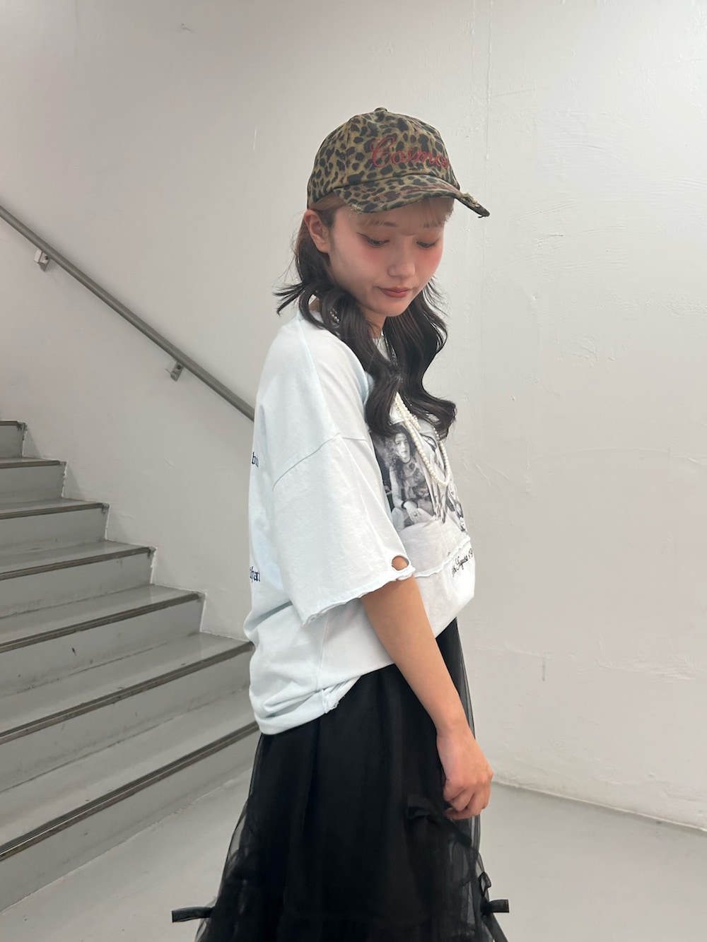 ブルー系のTシャツ/カットソー、ブラック系のスカート、ブラウン系のキャップを着用したレディースの夏コーディネートの6枚目の写真