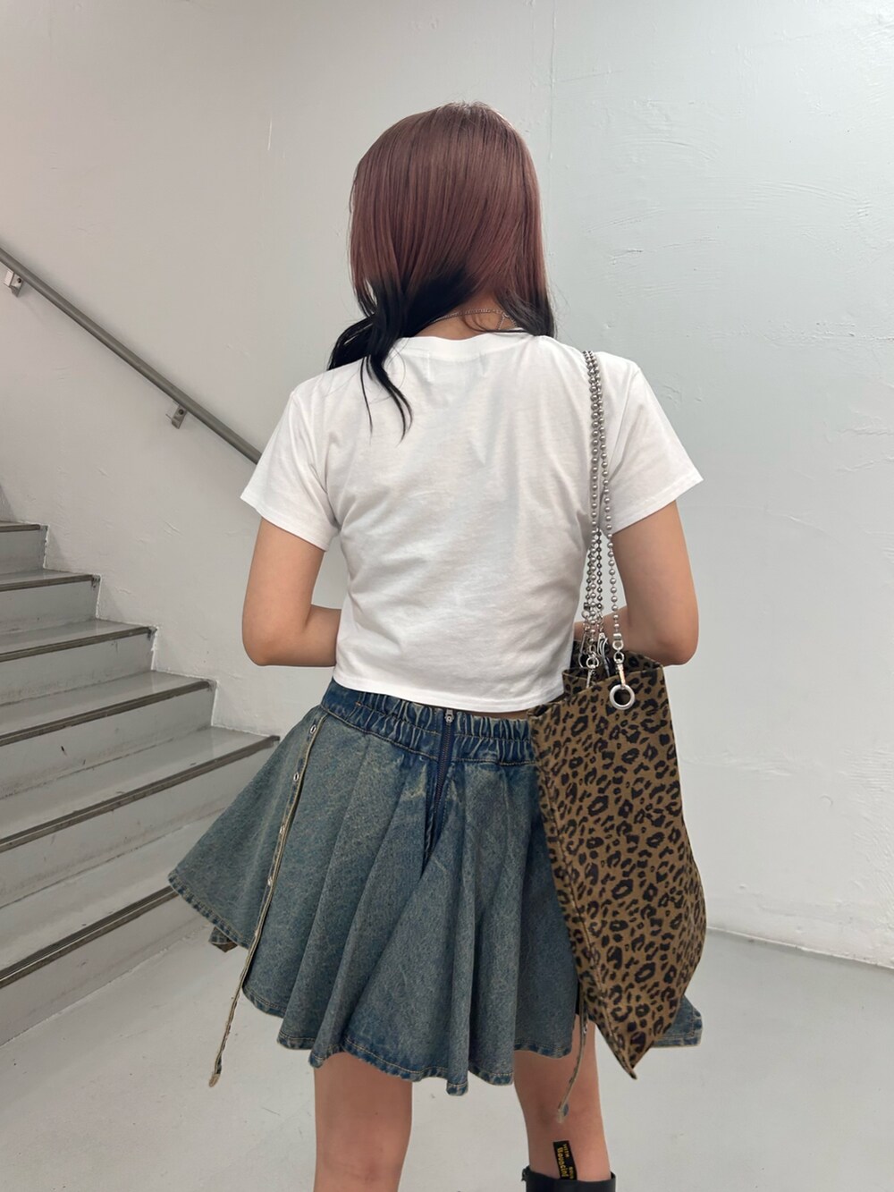 ホワイト系のTシャツ/カットソー、ブルー系のデニムスカート、ブラウン系のトートバッグを着用したレディースの夏コーディネートの6枚目の写真