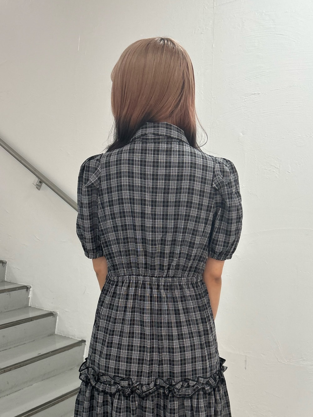 ブラック系のワンピース、ゴールド系のブレスレットを着用したレディースの夏コーディネートの6枚目の写真