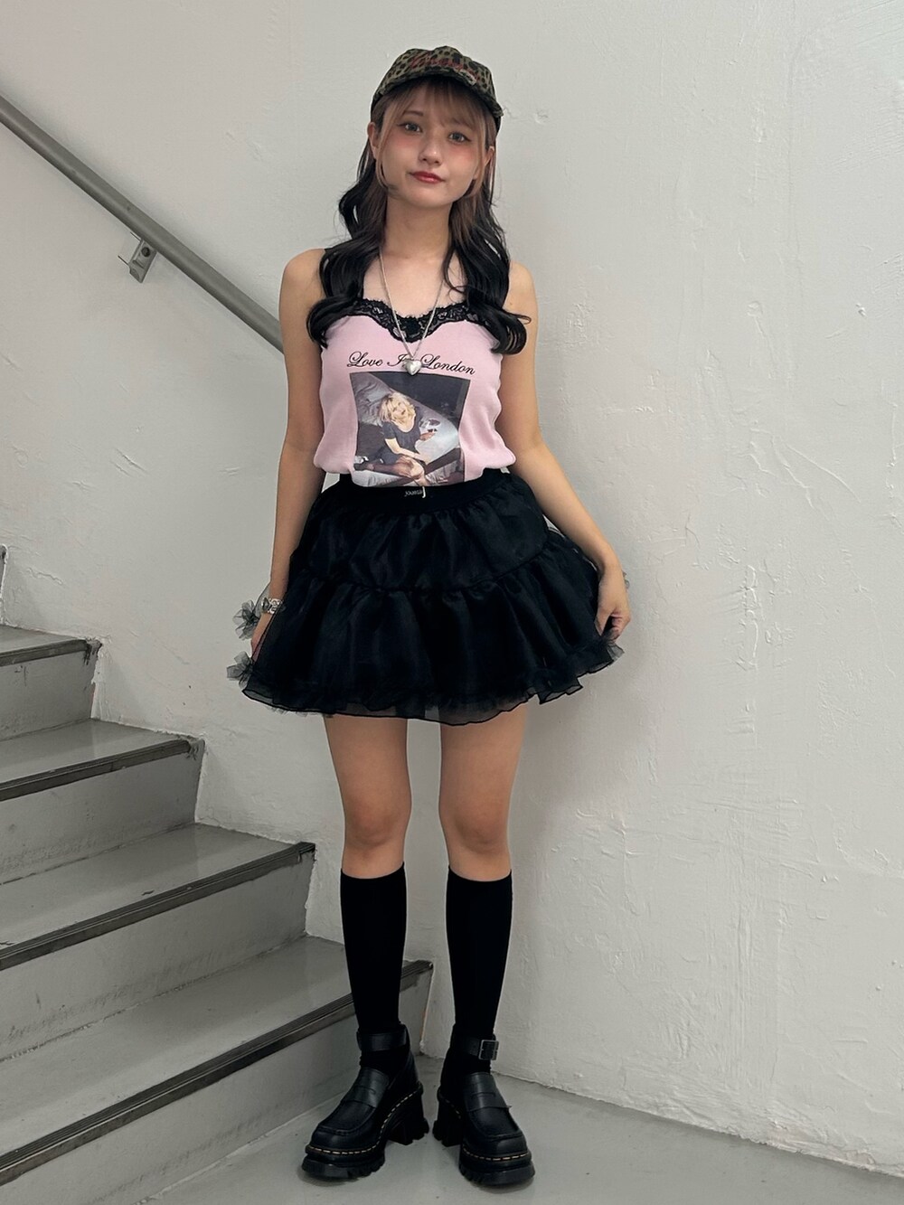 ピンク系のワンピース、ブラック系のスカート、シルバー系のネックレスを着用したレディースの夏コーディネートの2枚目の写真