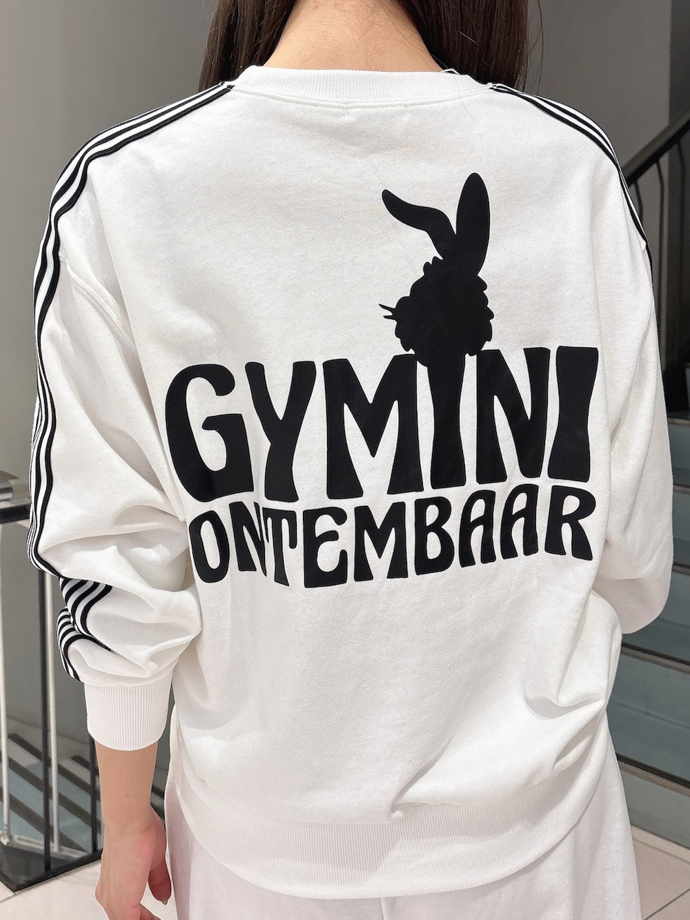 ホワイト系のスウェット、ホワイト系のスウェットパンツ、ブラック系のブーツを着用したレディースの冬コーディネートの5枚目の写真