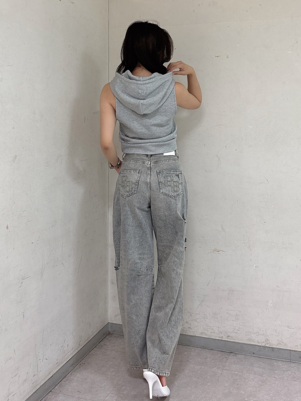 グレー系のTシャツ/カットソー、ブルー系のデニムパンツ、ホワイト系のパンプスを着用したレディースの夏コーディネートの3枚目の写真