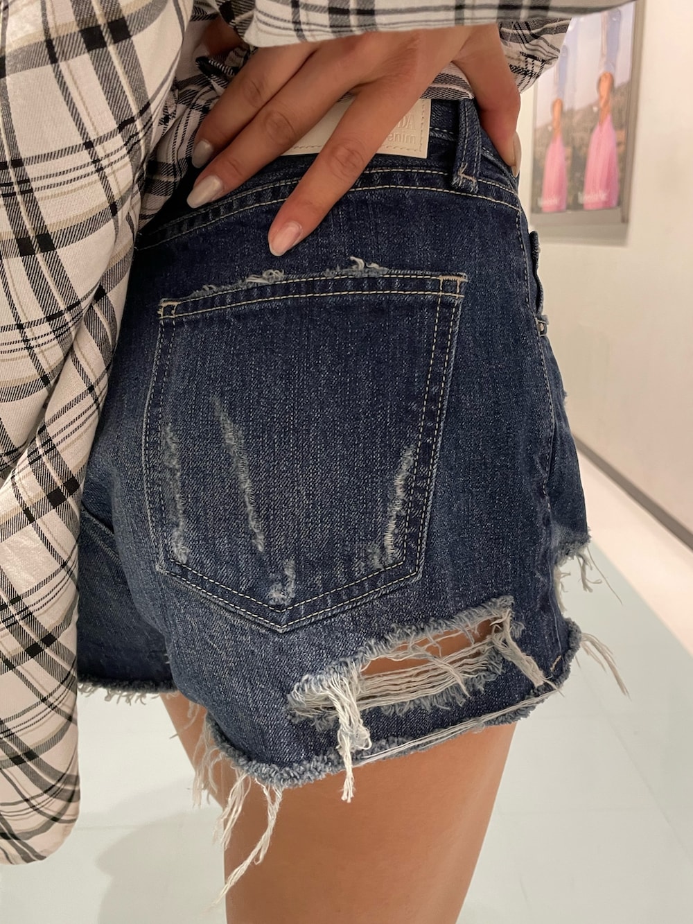 ホワイト系のキャミソール、ブルー系のデニムパンツ、ホワイト系のブーツを着用したレディースの春コーディネートの6枚目の写真