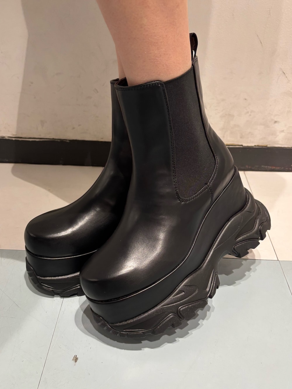 ピンク系のスウェット、ブラック系のハンドバッグ、ブラック系のブーツを着用したレディースの冬コーディネートの8枚目の写真