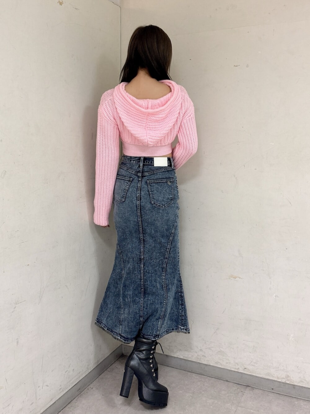 ブラック系のブーツ、ピンク系のニット/セーター、ブルー系のデニムスカートを着用したレディースの冬コーディネートの3枚目の写真