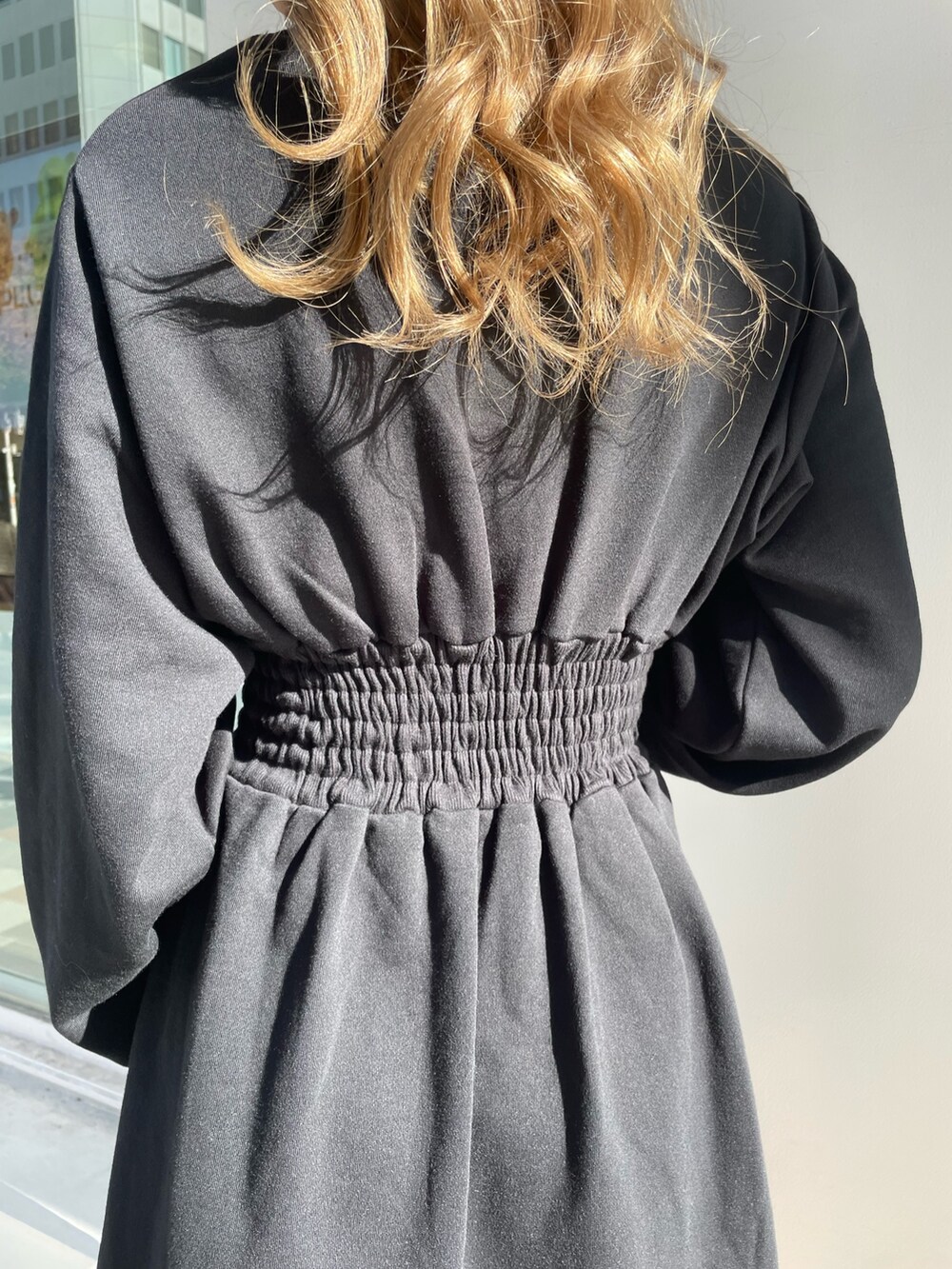 ブラック系のワンピース、ブラック系のブーツを着用したレディースの冬コーディネートの4枚目の写真