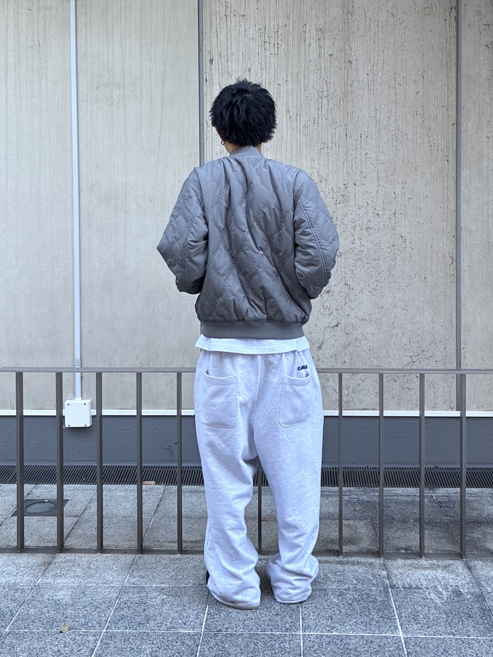 ブラック系のブルゾン、ホワイト系のTシャツ/カットソーを着用したメンズの冬コーディネートの4枚目の写真