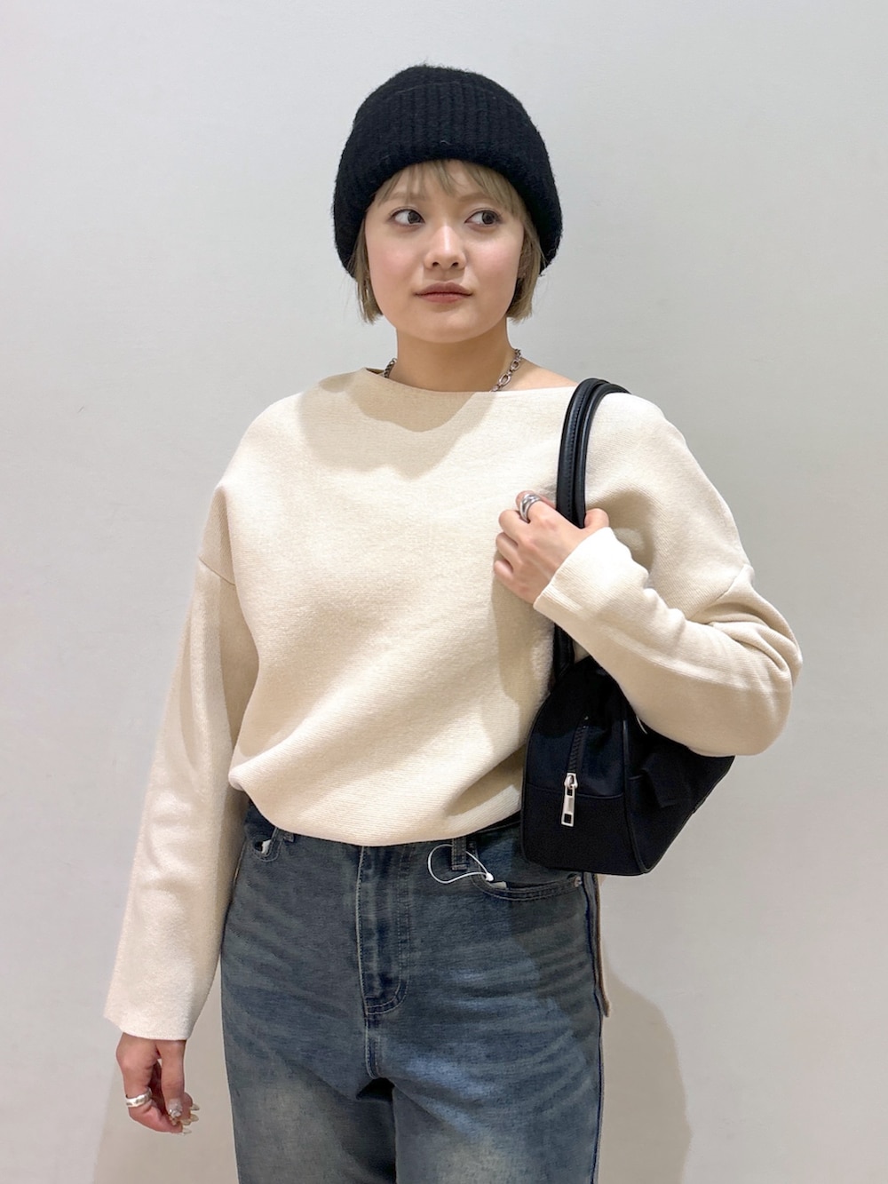 ホワイト系のニット/セーター、ブルー系のデニムパンツ、ブラック系のローファーを着用したレディースの冬コーディネートの4枚目の写真