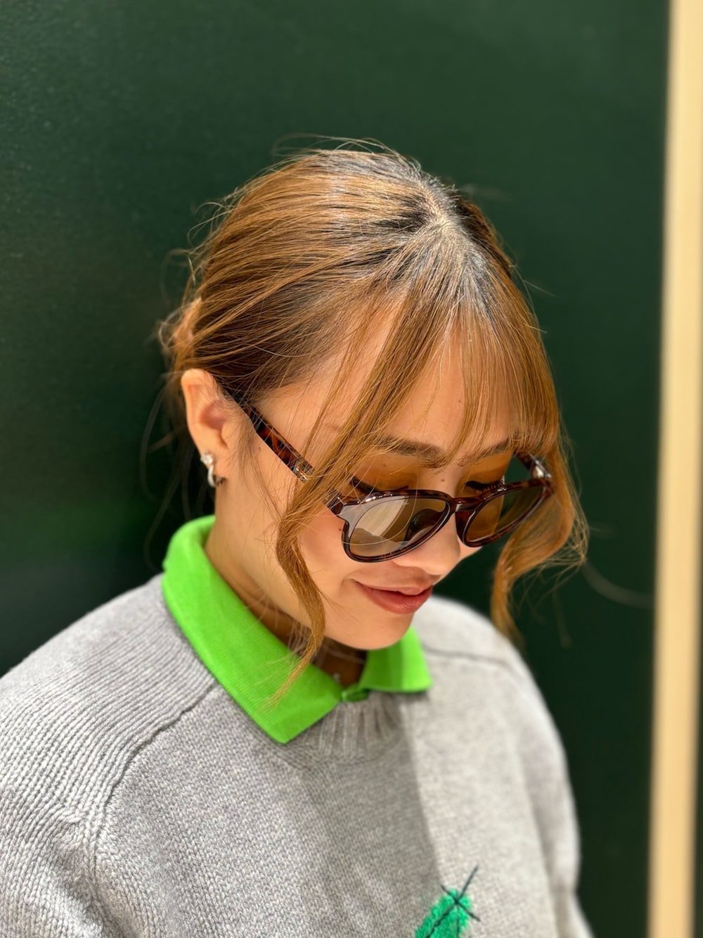 ブラウン系のブルゾン、グレー系のニット/セーター、ホワイト系のスカートを着用したレディースの夏コーディネートの7枚目の写真