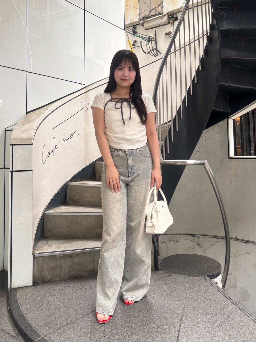 ホワイト系のTシャツ/カットソー、ブルー系のデニムパンツ、レッド系のサンダルを着用したレディースの春コーディネートの3枚目の写真