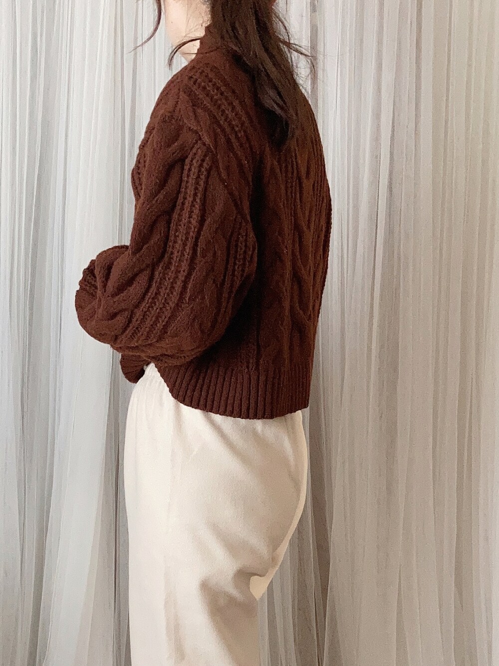 ホワイト系のジャケット/アウター、ブラウン系のニット/セーター、ホワイト系のその他パンツを着用したレディースの冬コーディネートの4枚目の写真