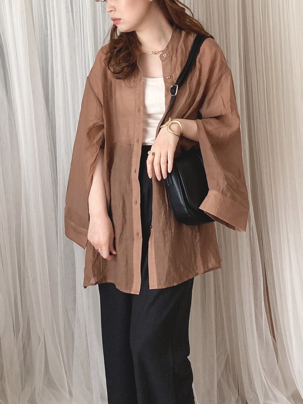 ブラウン系のシャツ/ブラウス、ブラック系のショルダーバッグ、ブラウン系のサンダルを着用したレディースの夏コーディネートの2枚目の写真