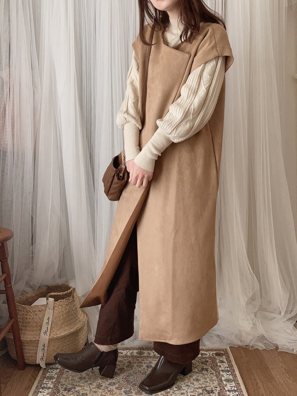 ブラウン系のショルダーバッグ、ベージュ系のその他アウター、ベージュ系のニット/セーターを着用したレディースの冬コーディネートの4枚目の写真