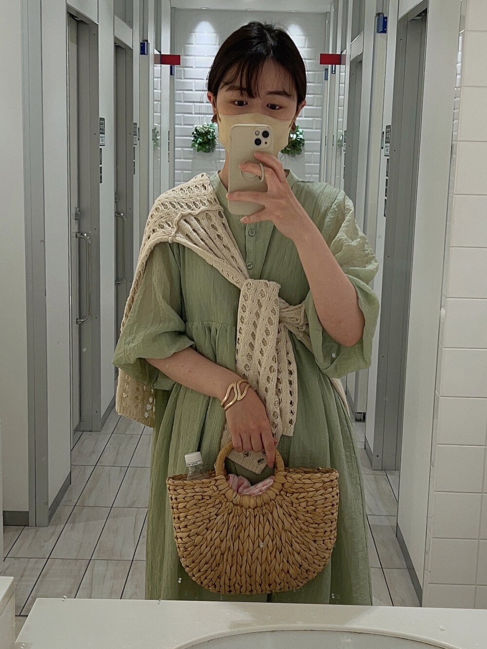 グリーン系のワンピース、ホワイト系のカーディガン/ボレロ、ベージュ系のシューズを着用したレディースの夏コーディネートの2枚目の写真