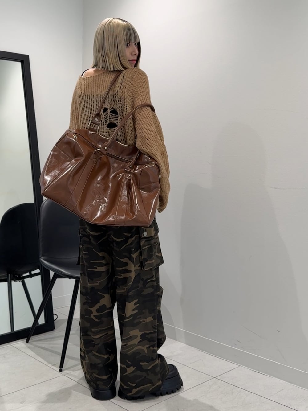 ベージュ系のニット/セーター、その他のカーゴパンツ、ブラウン系のボストンバッグを着用したレディースの秋コーディネートの2枚目の写真