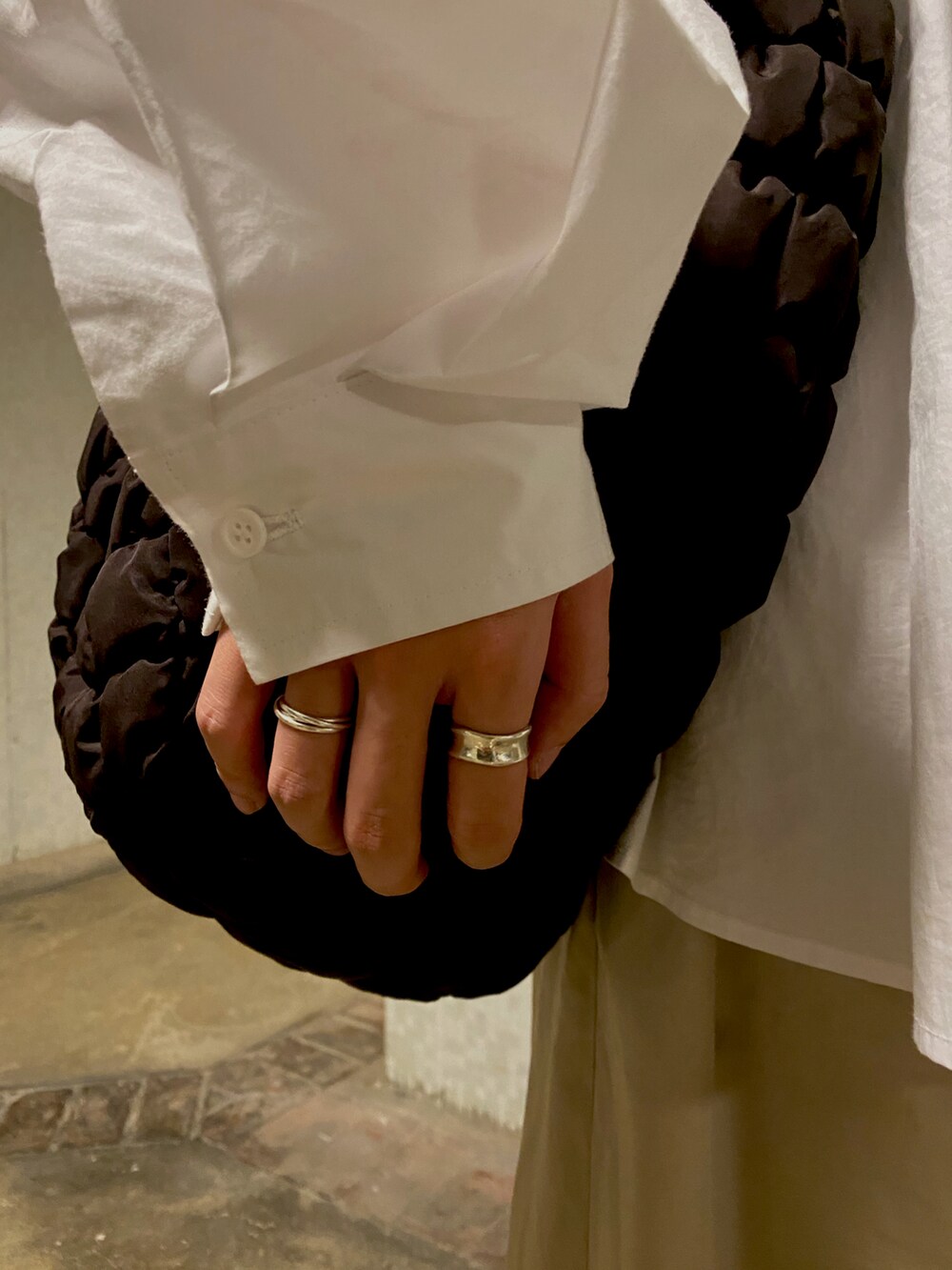 ベージュ系のチノパンツ、ブラウン系のバッグ、ブラック系のサンダルを着用したメンズの春コーディネートの2枚目の写真