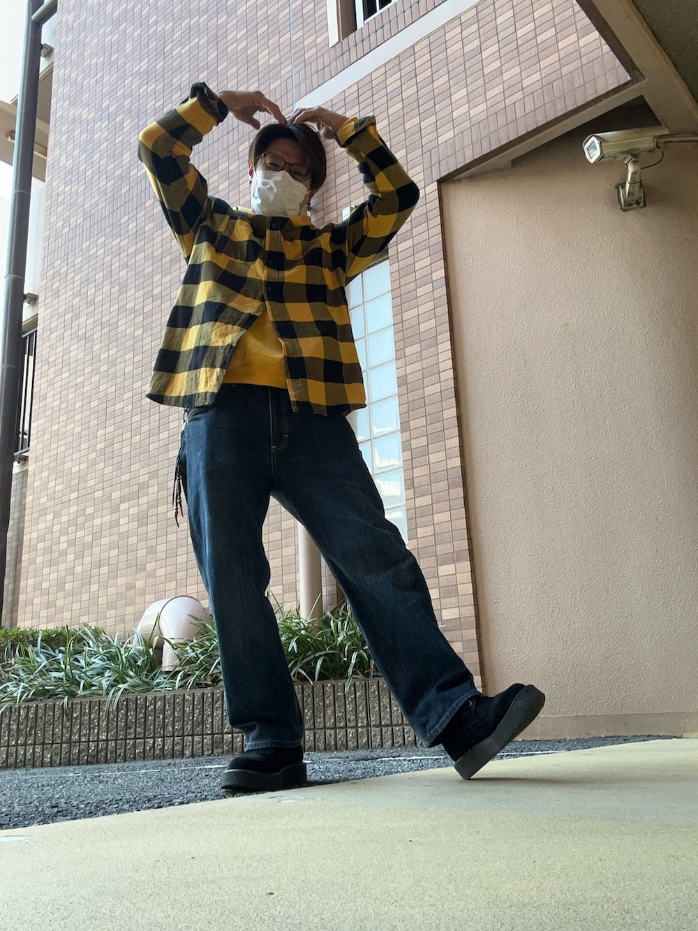 ブルー系のデニムパンツ、ブラック系のシューズ、イエロー系のシャツ/ブラウスを着用したメンズの冬コーディネートの3枚目の写真