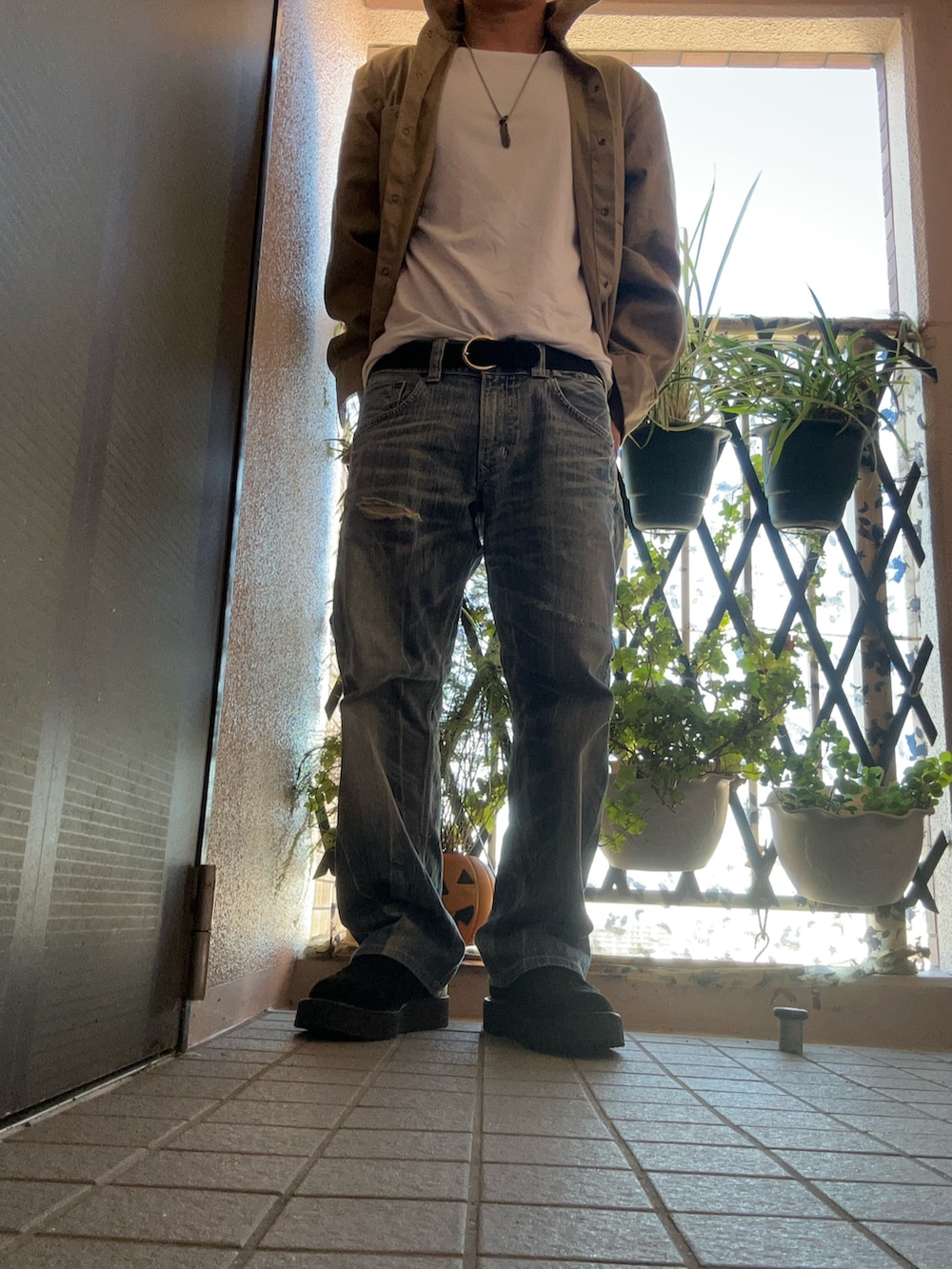 ホワイト系のTシャツ/カットソー、ベージュ系のジャケット/アウター、ブルー系のデニムパンツを着用したメンズの秋コーディネートの3枚目の写真