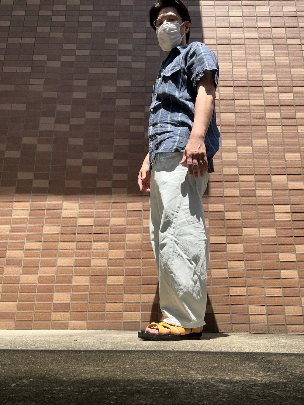 ブルー系のシャツ/ブラウス、ブルー系のデニムパンツ、ホワイト系のタンクトップを着用したメンズの夏コーディネートの2枚目の写真