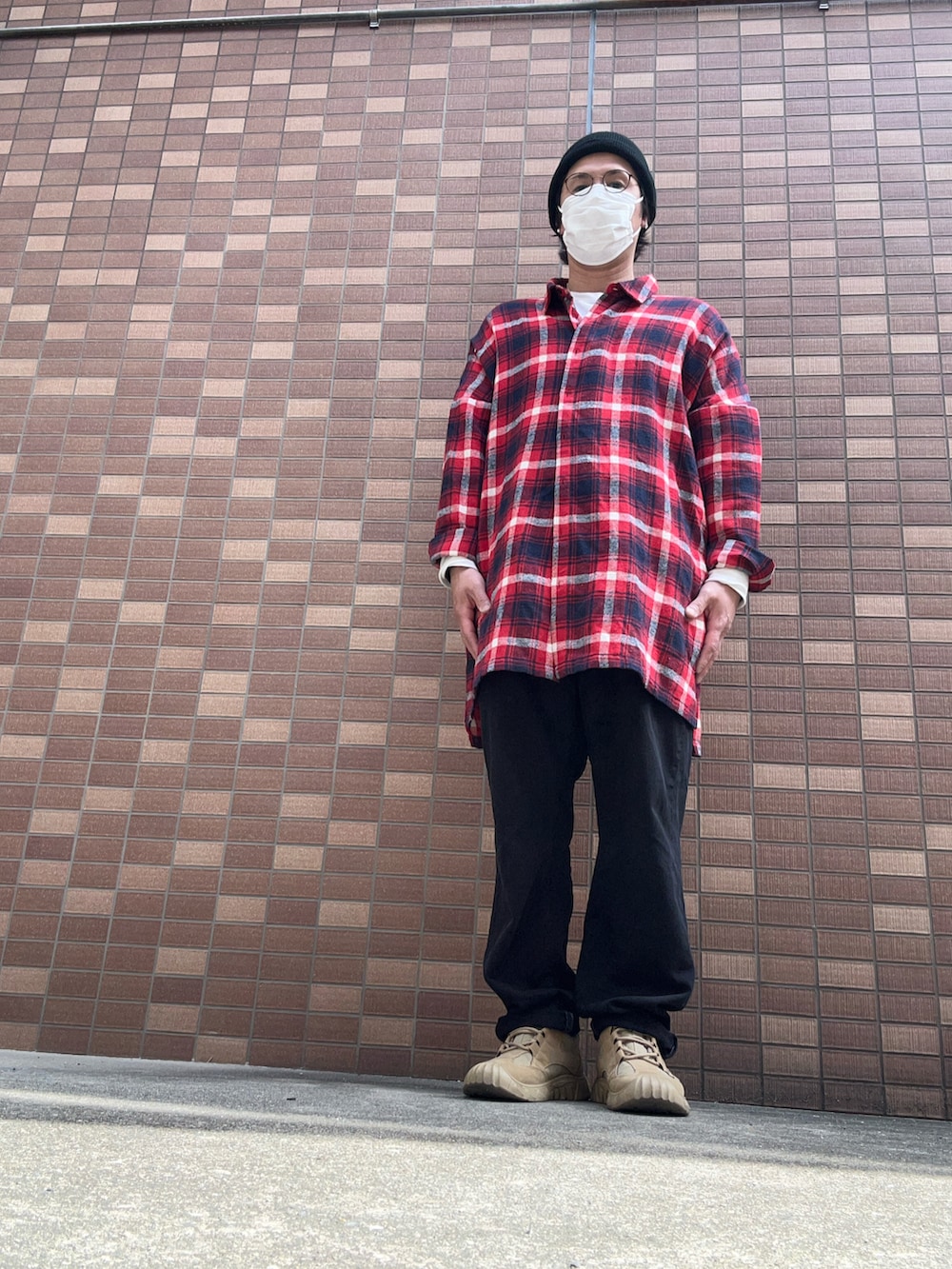 ブラック系のデニムパンツ、ホワイト系のTシャツ/カットソー、ベージュ系のスニーカーを着用したメンズの春コーディネートの3枚目の写真