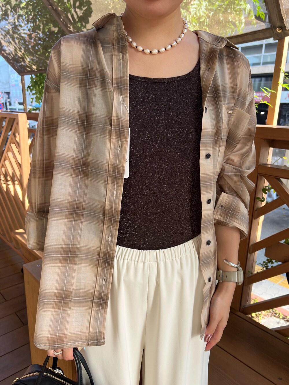 ブラウン系のタンクトップ、ベージュ系のシャツ/ブラウス、ホワイト系のその他パンツを着用したレディースの夏コーディネートの3枚目の写真