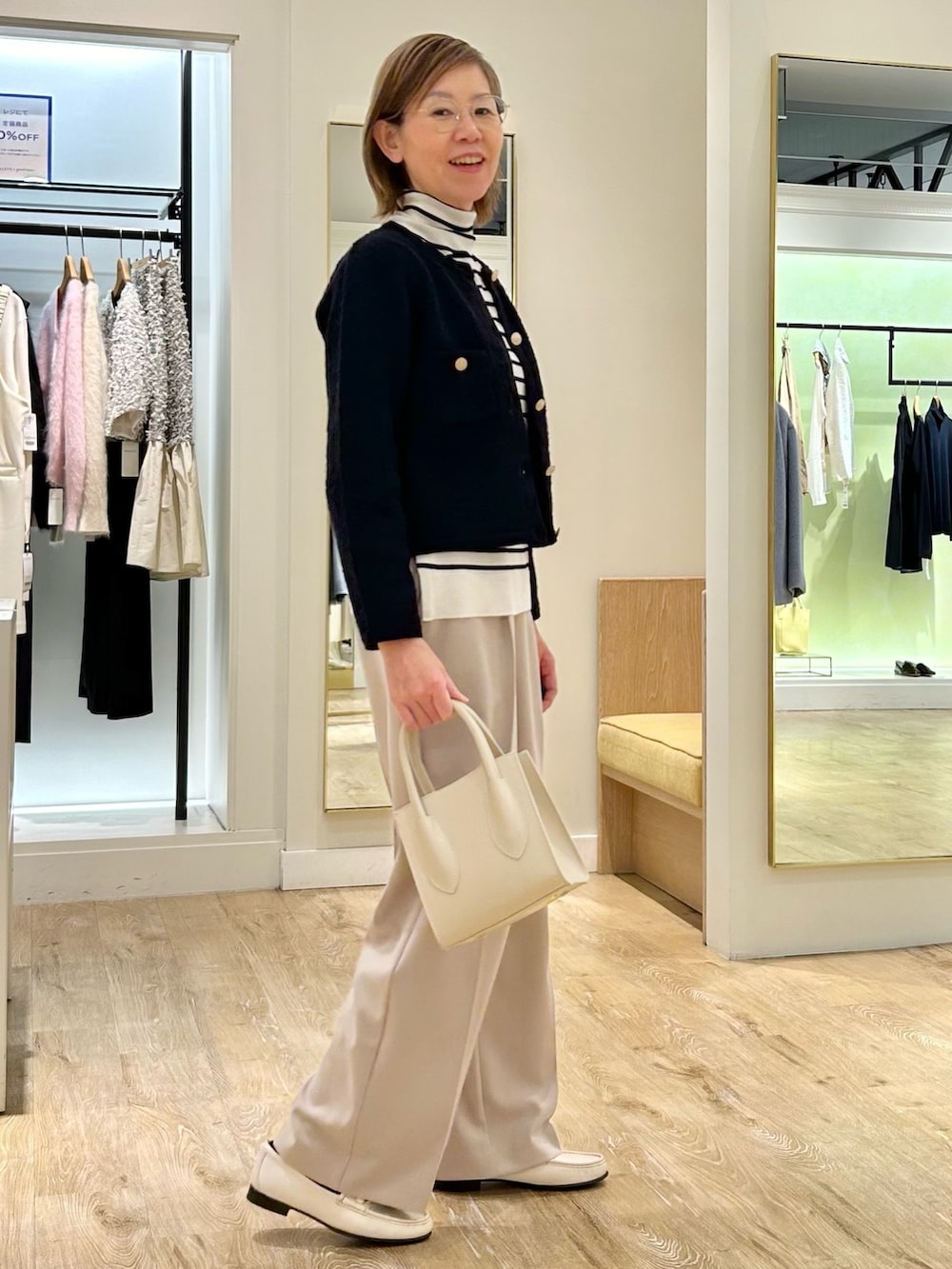 ベージュ系のその他パンツ、ホワイト系のニット/セーター、ブルー系のカーディガン/ボレロを着用したレディースの冬コーディネートの5枚目の写真