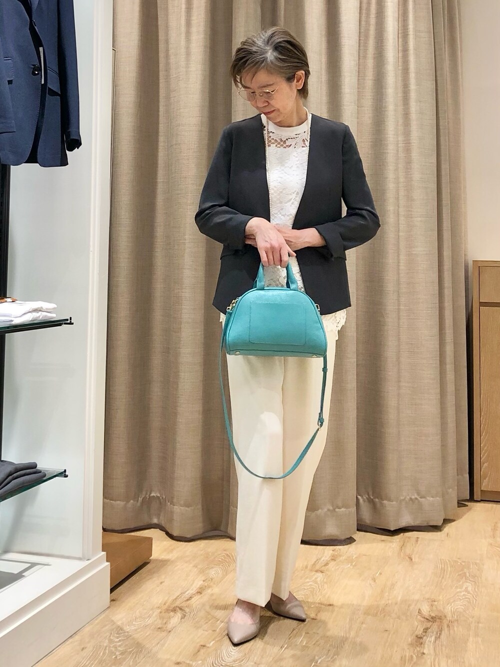 ホワイト系のその他パンツ、グリーン系のボストンバッグ、ホワイト系のシャツ/ブラウスを着用したレディースの夏コーディネートの2枚目の写真