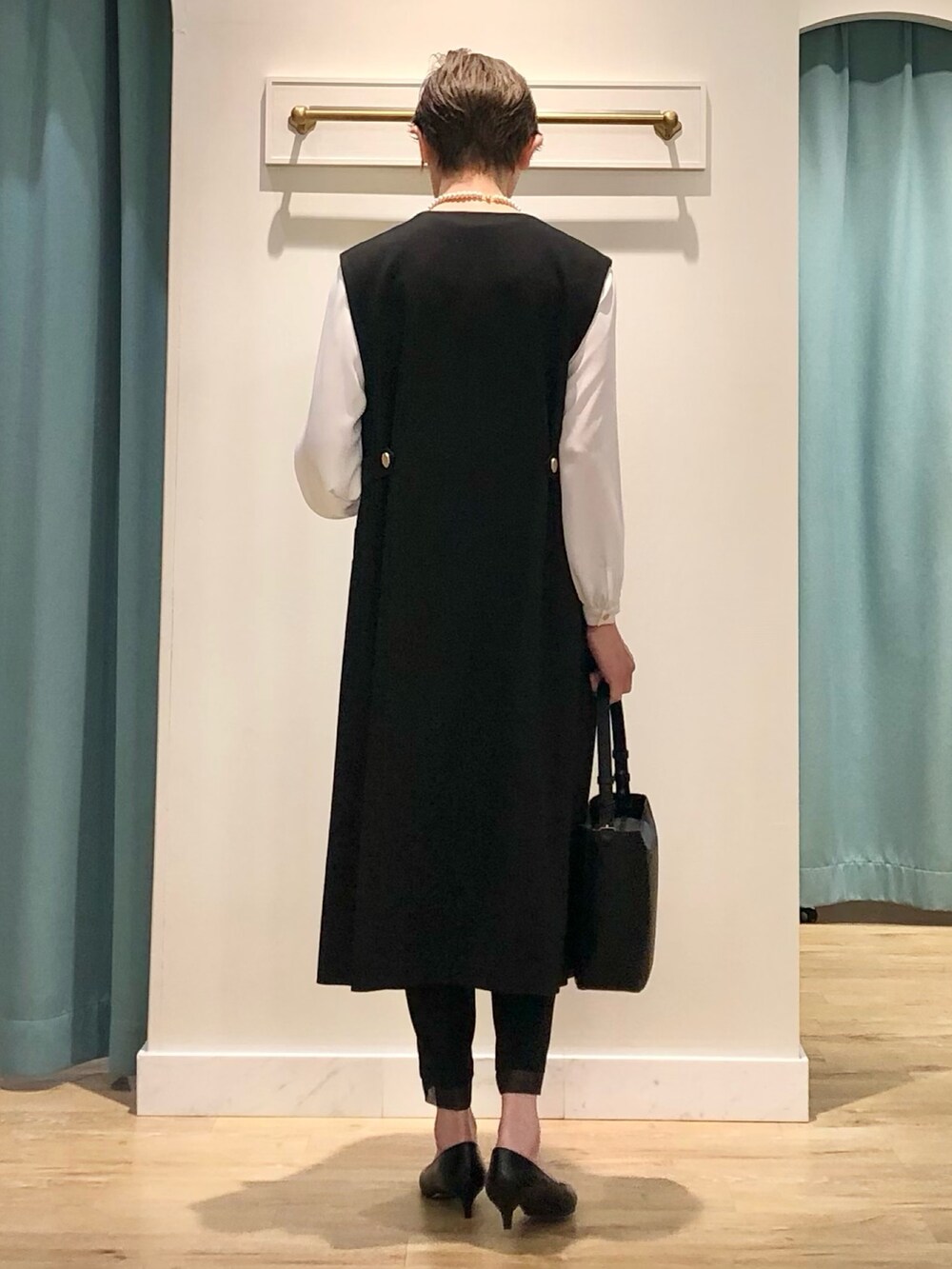 ブラック系のワンピース、ホワイト系のシャツ/ブラウス、ブラック系のその他パンツを着用したレディースの冬コーディネートの5枚目の写真