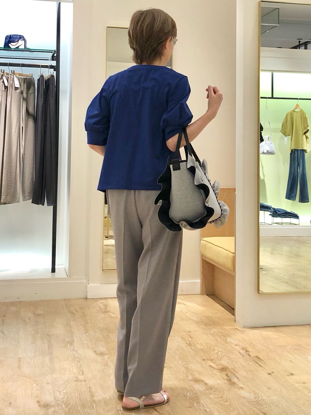 グレー系のその他パンツ、ブルー系のTシャツ/カットソー、グレー系のトートバッグを着用したレディースの夏コーディネートの5枚目の写真