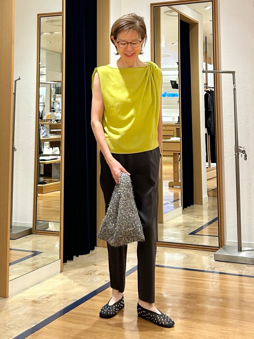 グレー系のその他パンツ、イエロー系のシャツ/ブラウス、ブラック系のバックパック/リュックを着用したレディースの夏コーディネートの3枚目の写真