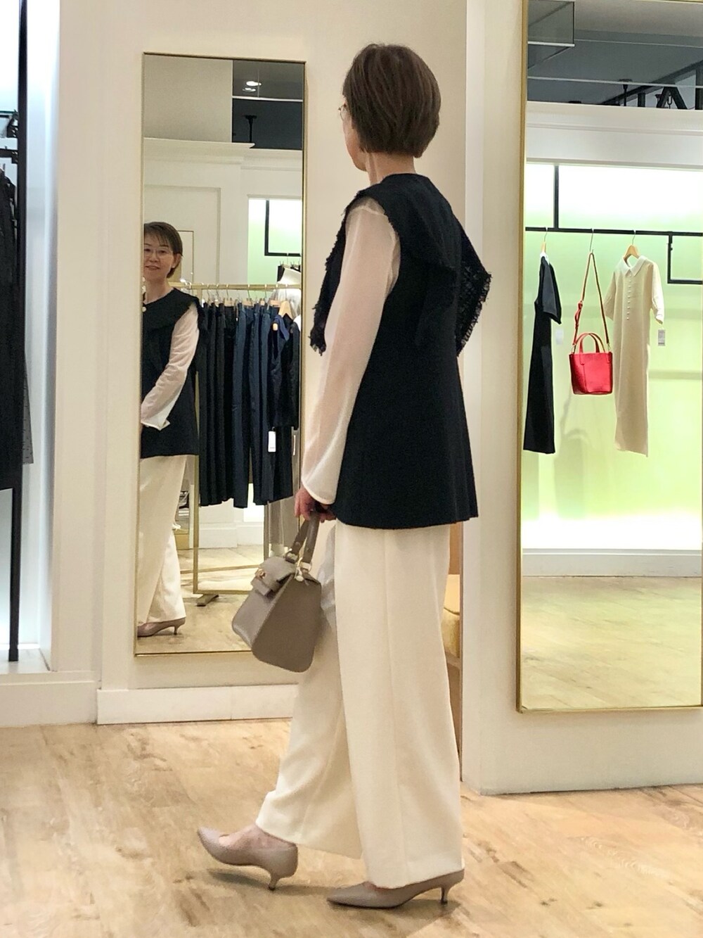 ホワイト系のその他パンツ、ホワイト系のTシャツ/カットソー、ブルー系のベストを着用したレディースの夏コーディネートの5枚目の写真