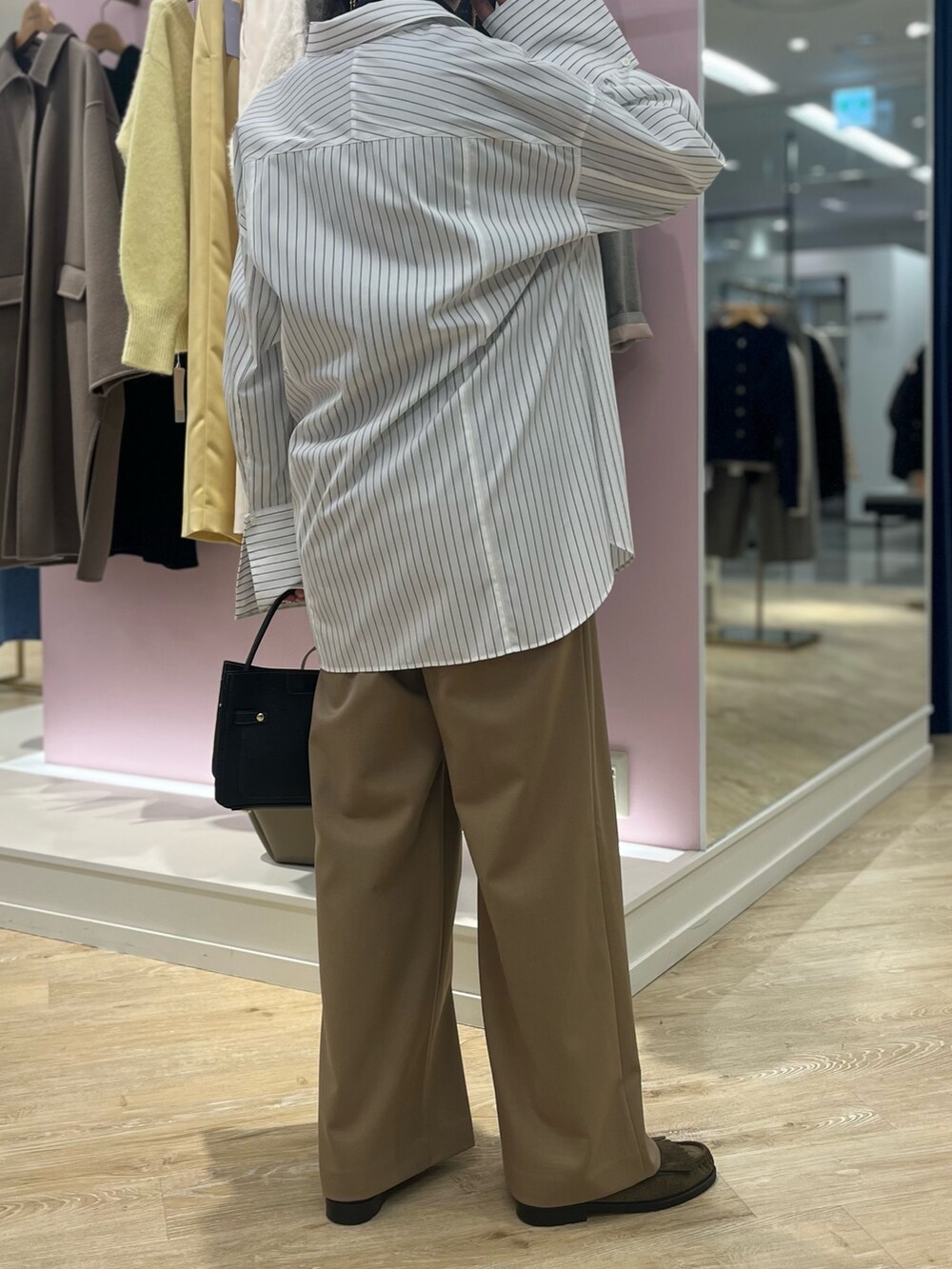 ホワイト系のシャツ/ブラウス、イエロー系のその他パンツ、ブラック系のショルダーバッグを着用したレディースの秋コーディネートの4枚目の写真