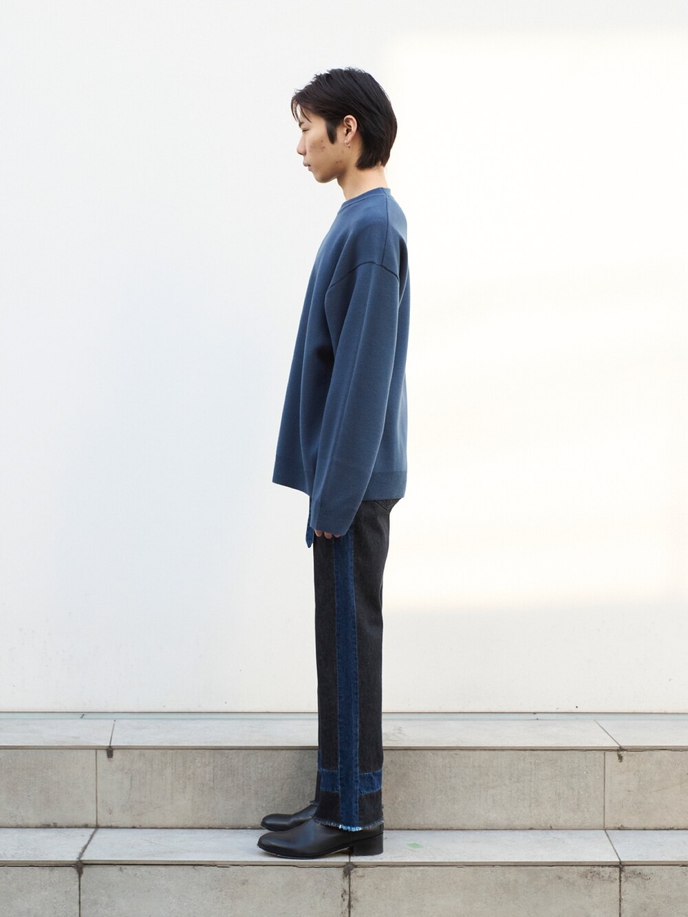 グレー系のニット/セーターを着用したメンズの冬コーディネートの2枚目の写真