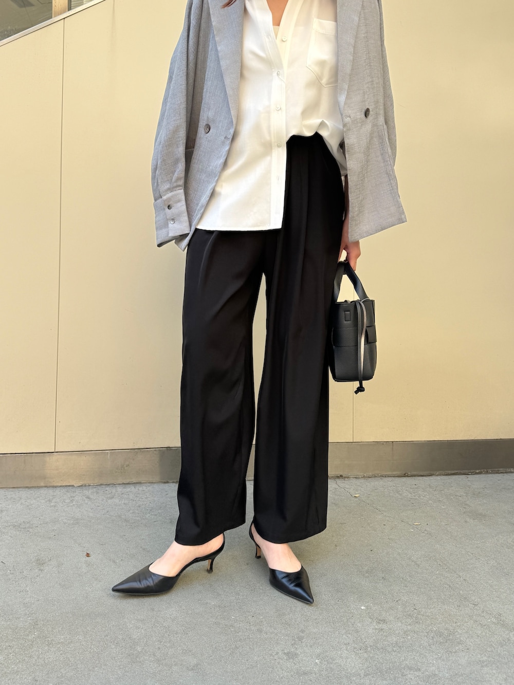ブラック系のその他パンツ、ホワイト系のシャツ/ブラウス、グレー系のテーラードジャケットを着用したレディースの春コーディネートの3枚目の写真